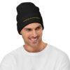 Black knit beanie with yellow text reading Average Is The Enemy
